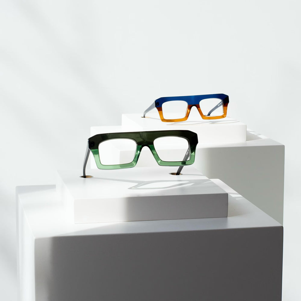 Montures de lunettes en acétate coloré exposées sur socles — collection Marie-Sophie Dion